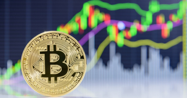 Bitcoin on stock market candlestick background