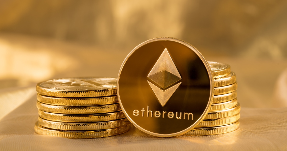 Stack of ether coins or ethereum on gold background to illustrate blockchain