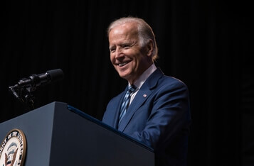 Biden urges technology firms to prioritize safety in AI development